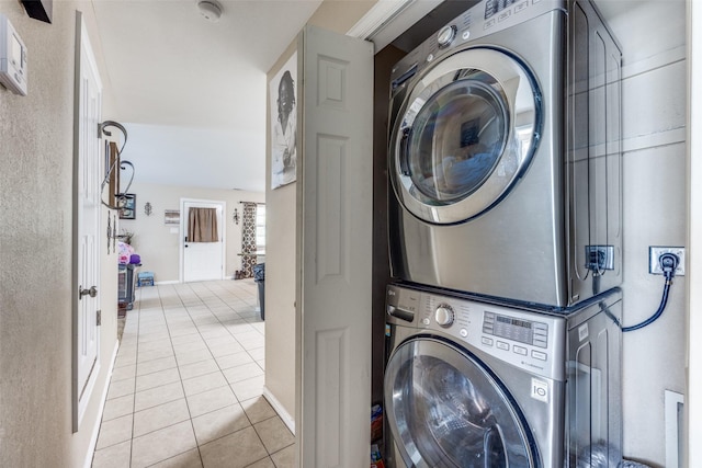 318 E Chestnut St, Denison, TX 75021 - laundry room featuring stacked washer and clothes dryer and light tile patterned floors