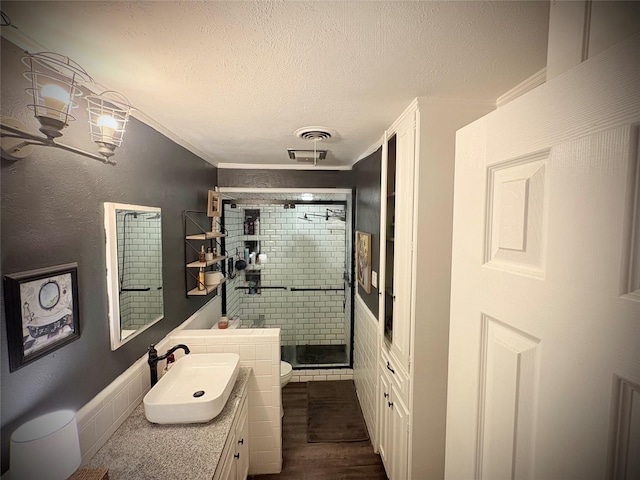 4124 Maryview Ct, Haltom City, TX 76117 - full bathroom with a stall shower, vanity, ornamental molding, a textured ceiling, and wood finished floors