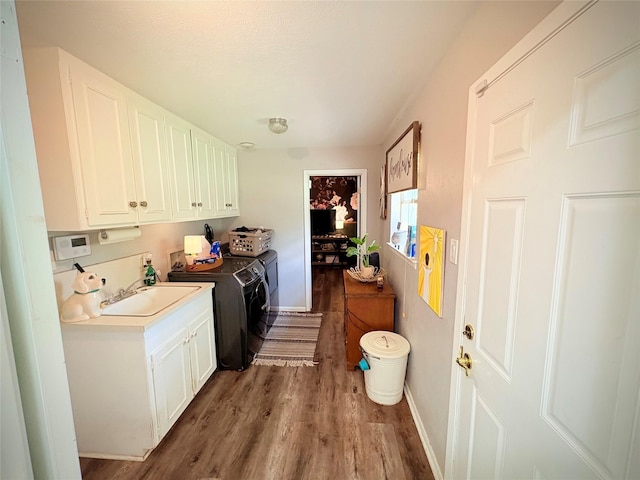 4124 Maryview Ct, Haltom City, TX 76117 - washroom with independent washer and dryer, wood finished floors, and cabinet space