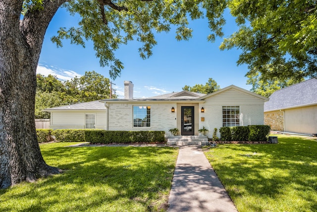 4903 Wateka Dr, Dallas, TX 75209 - ranch-style home featuring a chimney, a front yard, and brick siding
