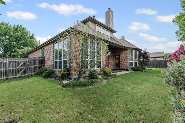 1904 Yarmouth Ct, Mansfield, TX 76063 - back of house with brick siding, a chimney, and a fenced backyard