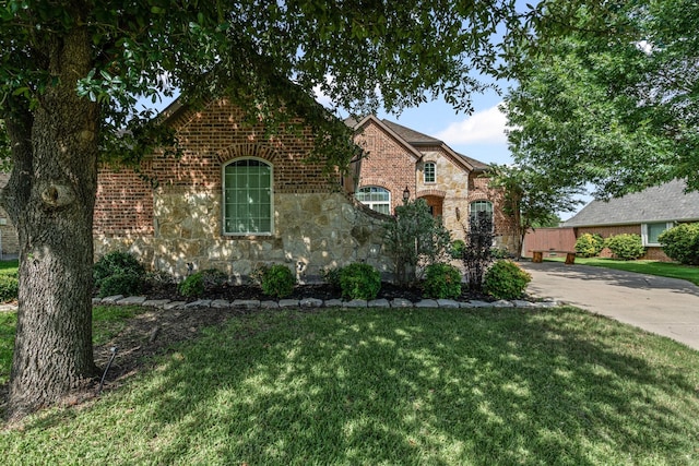 1904 Yarmouth Ct, Mansfield, TX 76063 - view of front of property with stone siding, a front lawn, driveway, and brick siding