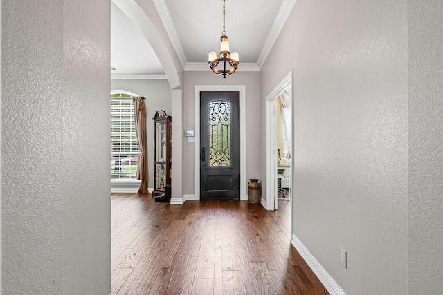 1904 Yarmouth Ct, Mansfield, TX 76063 - entryway with a textured wall, a chandelier, dark wood-style flooring, arched walkways, and ornamental molding