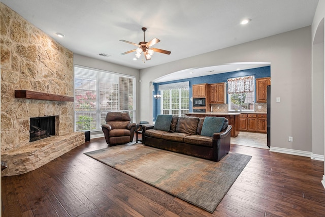 1904 Yarmouth Ct, Mansfield, TX 76063 - living room featuring a ceiling fan, dark wood-style floors, a fireplace, recessed lighting, and arched walkways