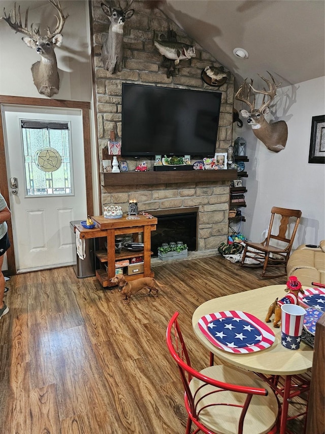3004 Seagull Rd, Kerens, TX 75144 - living room featuring wood finished floors, a stone fireplace, and vaulted ceiling