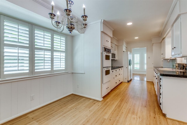 4818 Thunder Rd, Dallas, TX 75244 - kitchen featuring a chandelier, light wood finished floors, dark countertops, white cabinetry, and recessed lighting