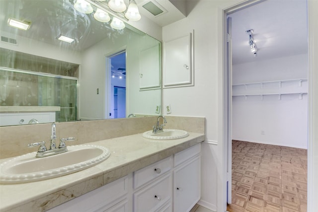 4818 Thunder Rd, Dallas, TX 75244 - bathroom featuring double vanity, a shower stall, and a spacious closet