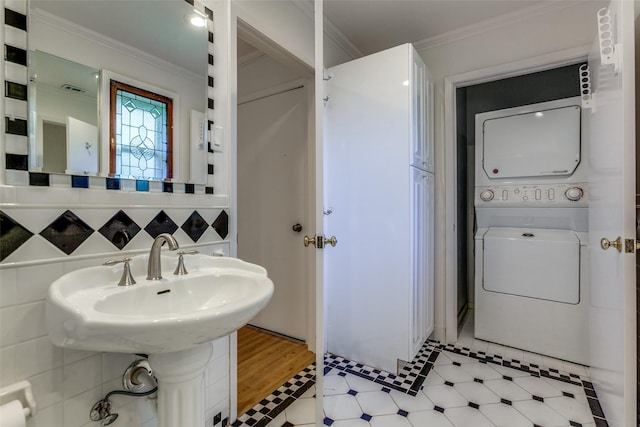 4818 Thunder Rd, Dallas, TX 75244 - bathroom with stacked washer / dryer, crown molding, and tile patterned floors