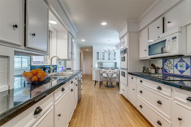4818 Thunder Rd, Dallas, TX 75244 - kitchen featuring white appliances, a chandelier, light wood-style floors, white cabinets, and recessed lighting