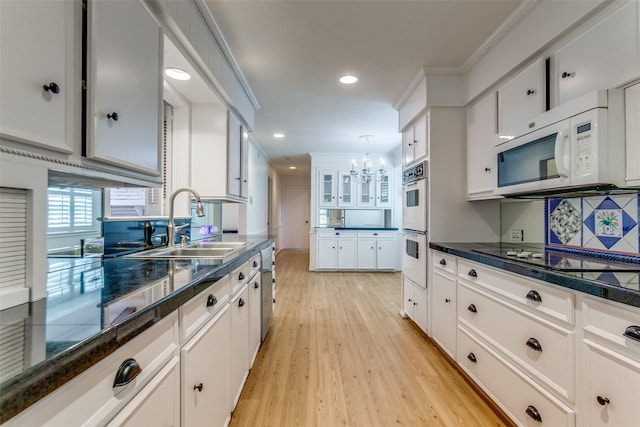 4818 Thunder Rd, Dallas, TX 75244 - kitchen featuring white appliances, light wood-type flooring, white cabinetry, a chandelier, and recessed lighting