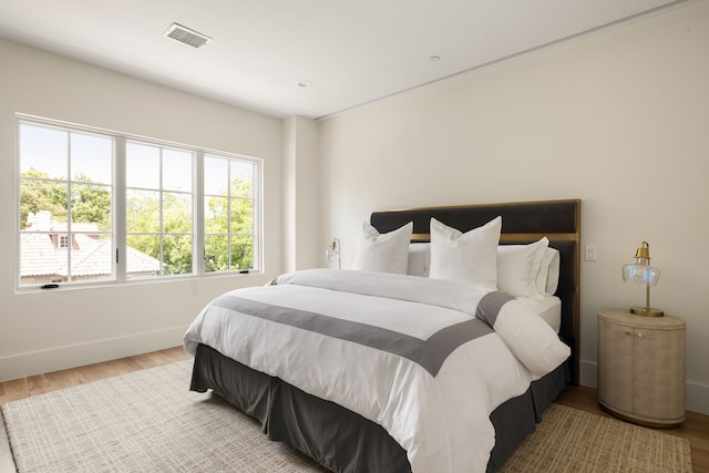3939 Hawthorne Unit 103, Dallas, TX 75219 - bedroom featuring baseboards and wood finished floors