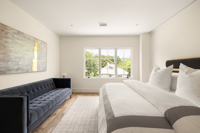 3939 Hawthorne Unit 103, Dallas, TX 75219 - bedroom with light wood-style flooring and baseboards