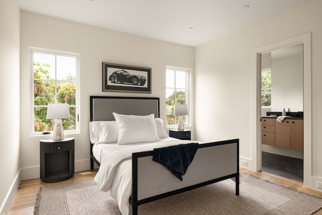 3939 Hawthorne Unit 103, Dallas, TX 75219 - bedroom with light wood-style flooring and ensuite bathroom
