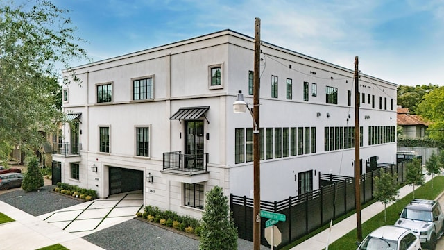 3939 Hawthorne Unit 103, Dallas, TX 75219 - view of building exterior featuring a garage and driveway