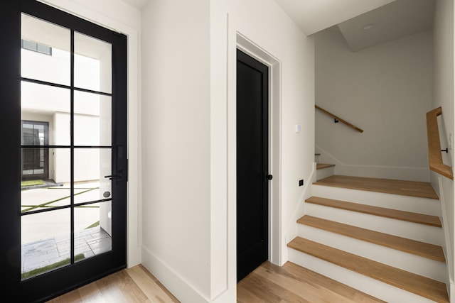 3939 Hawthorne Unit 103, Dallas, TX 75219 - stairs featuring wood finished floors and baseboards