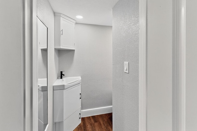 1521 Windsor Dr, Glenn Heights, TX 75154 - bathroom featuring vanity, wood finished floors, and a textured wall