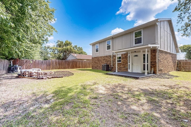 1521 Windsor Dr, Glenn Heights, TX 75154 - back of house with brick siding, board and batten siding, a patio area, and a fenced backyard