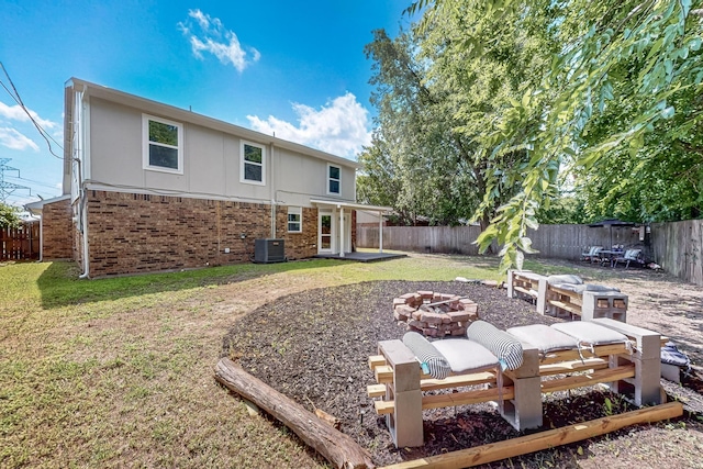 1521 Windsor Dr, Glenn Heights, TX 75154 - back of house featuring a fire pit, a fenced backyard, brick siding, and stucco siding