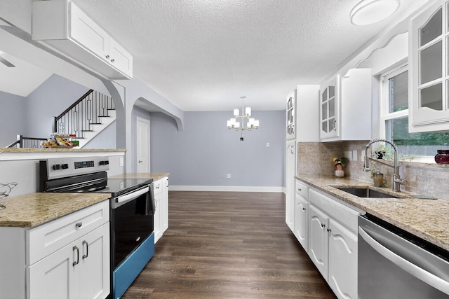 1521 Windsor Dr, Glenn Heights, TX 75154 - kitchen with stainless steel appliances, a chandelier, dark wood-style floors, decorative backsplash, and glass insert cabinets