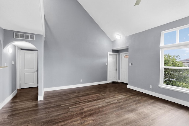 1521 Windsor Dr, Glenn Heights, TX 75154 - unfurnished room featuring high vaulted ceiling, arched walkways, dark wood-type flooring, and a ceiling fan