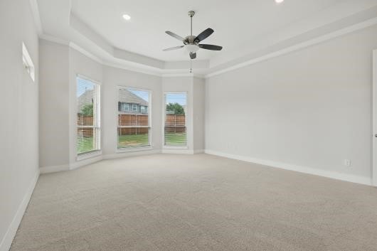 521 Winslow Ln, Prosper, TX 75078 - carpeted spare room with healthy amount of natural light, a tray ceiling, ceiling fan, recessed lighting, and ornamental molding