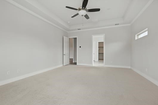 521 Winslow Ln, Prosper, TX 75078 - spare room featuring light colored carpet, a ceiling fan, and a raised ceiling