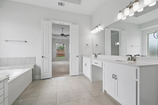 521 Winslow Ln, Prosper, TX 75078 - bathroom featuring vanity, ceiling fan, a bath, and tile patterned flooring
