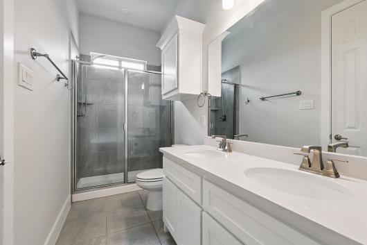 521 Winslow Ln, Prosper, TX 75078 - bathroom with a stall shower, double vanity, and tile patterned flooring