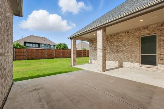 521 Winslow Ln, Prosper, TX 75078 - fenced backyard with a patio area