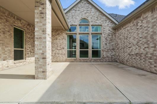 521 Winslow Ln, Prosper, TX 75078 - doorway to property with a patio area and brick siding