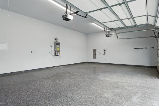 521 Winslow Ln, Prosper, TX 75078 - garage with a garage door opener, strapped water heater, and electric panel