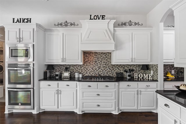 605 Pine Island Cir, Mansfield, TX 76063 - kitchen with dark countertops, arched walkways, and white cabinets