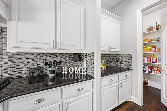 605 Pine Island Cir, Mansfield, TX 76063 - kitchen with white cabinets, decorative backsplash, dark wood-style floors, and dark stone counters