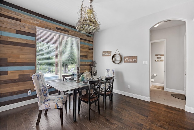605 Pine Island Cir, Mansfield, TX 76063 - dining area featuring wooden walls, arched walkways, and wood finished floors