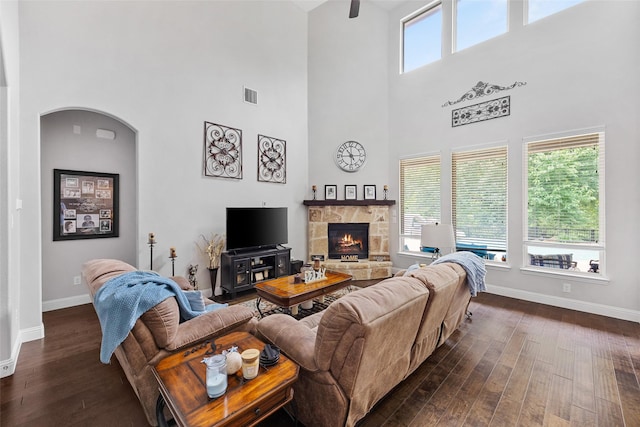 605 Pine Island Cir, Mansfield, TX 76063 - living area with dark wood-type flooring, a high ceiling, a fireplace, and a ceiling fan