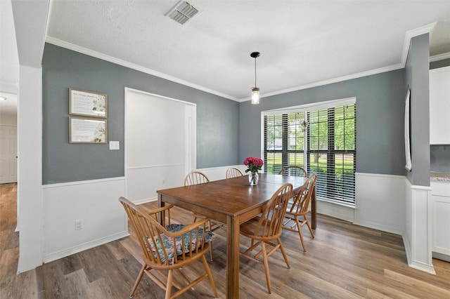 1105 Maree Dr, Waxahachie, TX 75165 - dining space featuring ornamental molding, light wood-style floors, and a wainscoted wall