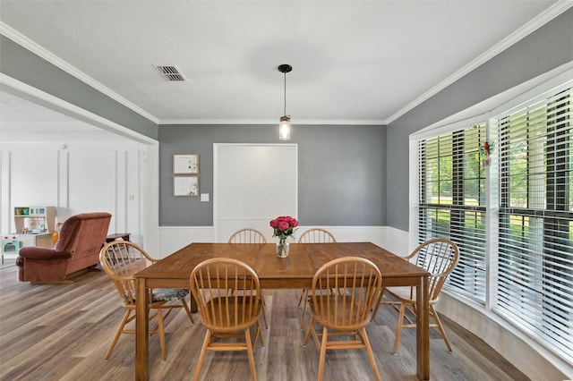 1105 Maree Dr, Waxahachie, TX 75165 - dining area with wood finished floors, wainscoting, and ornamental molding