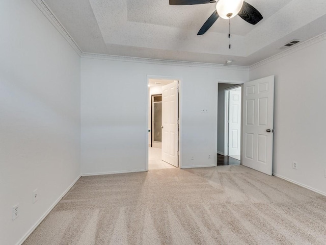 225 Mountainview Dr, Hurst, TX 76054 - unfurnished bedroom with a raised ceiling, carpet floors, ornamental molding, connected bathroom, and ceiling fan