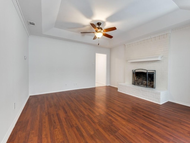 225 Mountainview Dr, Hurst, TX 76054 - unfurnished living room with a ceiling fan, a brick fireplace, wood finished floors, and a tray ceiling