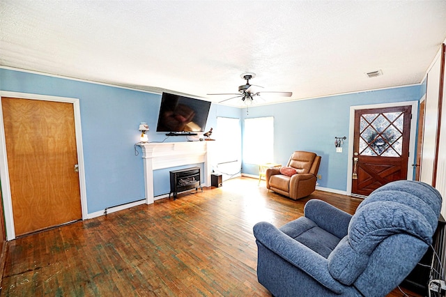 1561 Fm 1816, Bowie, TX 76230 - living room featuring wood-type flooring, ceiling fan, and a fireplace