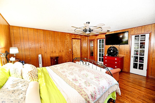 1561 Fm 1816, Bowie, TX 76230 - bedroom featuring wood walls, wood finished floors, and ceiling fan