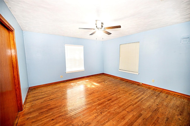 1561 Fm 1816, Bowie, TX 76230 - unfurnished room with ceiling fan and hardwood / wood-style flooring