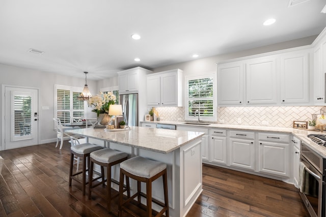 750 Camden Way, Prosper, TX 75078 - kitchen featuring appliances with stainless steel finishes, a center island, white cabinetry, and recessed lighting
