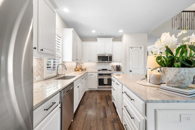 750 Camden Way, Prosper, TX 75078 - kitchen with stainless steel appliances, white cabinetry, tasteful backsplash, dark wood finished floors, and recessed lighting