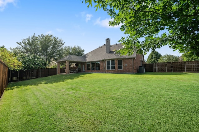 750 Camden Way, Prosper, TX 75078 - back of house with a fenced backyard, brick siding, a chimney, and a gazebo