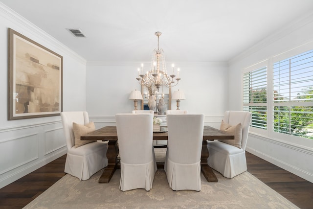 750 Camden Way, Prosper, TX 75078 - dining area featuring wood finished floors, a chandelier, crown molding, a wainscoted wall, and a decorative wall