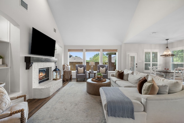 750 Camden Way, Prosper, TX 75078 - living room with wood finished floors, high vaulted ceiling, and a glass covered fireplace