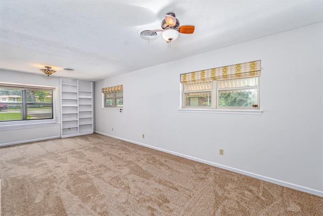 5912 Whitman Ave, Fort Worth, TX 76133 - carpeted spare room featuring a textured ceiling, ceiling fan, and built in shelves
