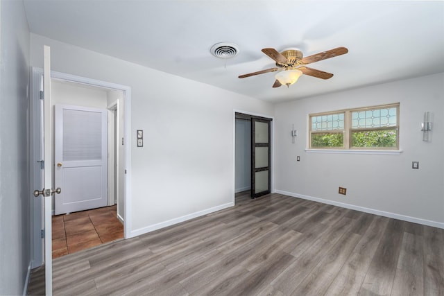 5912 Whitman Ave, Fort Worth, TX 76133 - unfurnished bedroom with a closet, wood finished floors, and ceiling fan