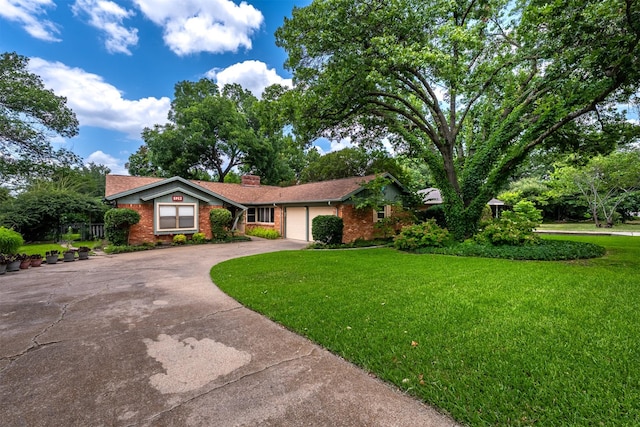5912 Whitman Ave, Fort Worth, TX 76133 - view of front facade featuring concrete driveway, brick siding, a front yard, and an attached garage